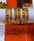 Gold bangles on a display stand with Sawra Gold packaging in the background.